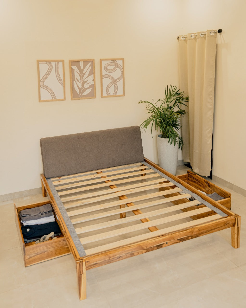 Wooden bed frame with storage drawers in a room setting.