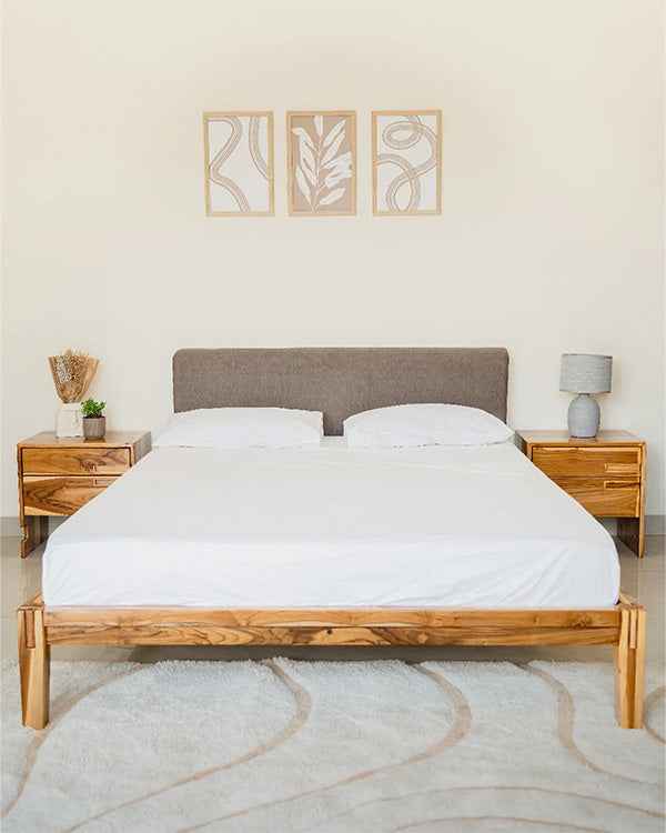 Bedroom with wooden bed frame, white bedding, and matching nightstands.