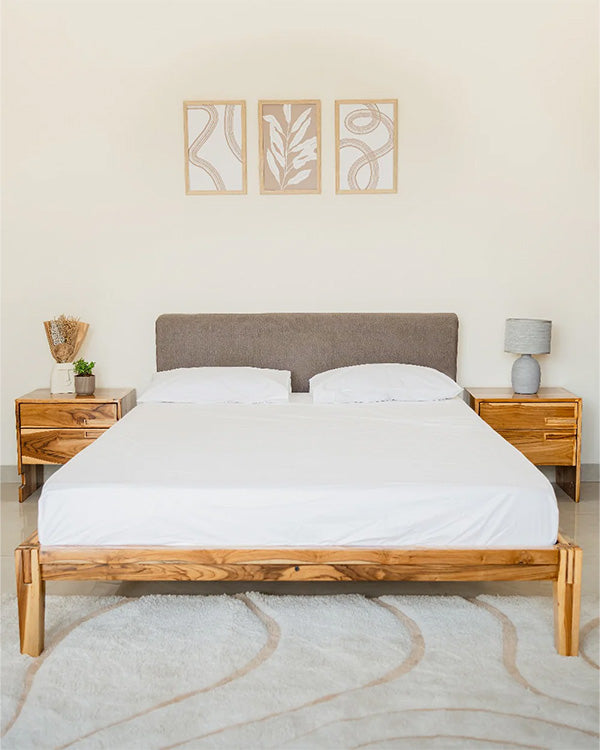 Bedroom with wooden bed frame, white bedding, and matching nightstands.
