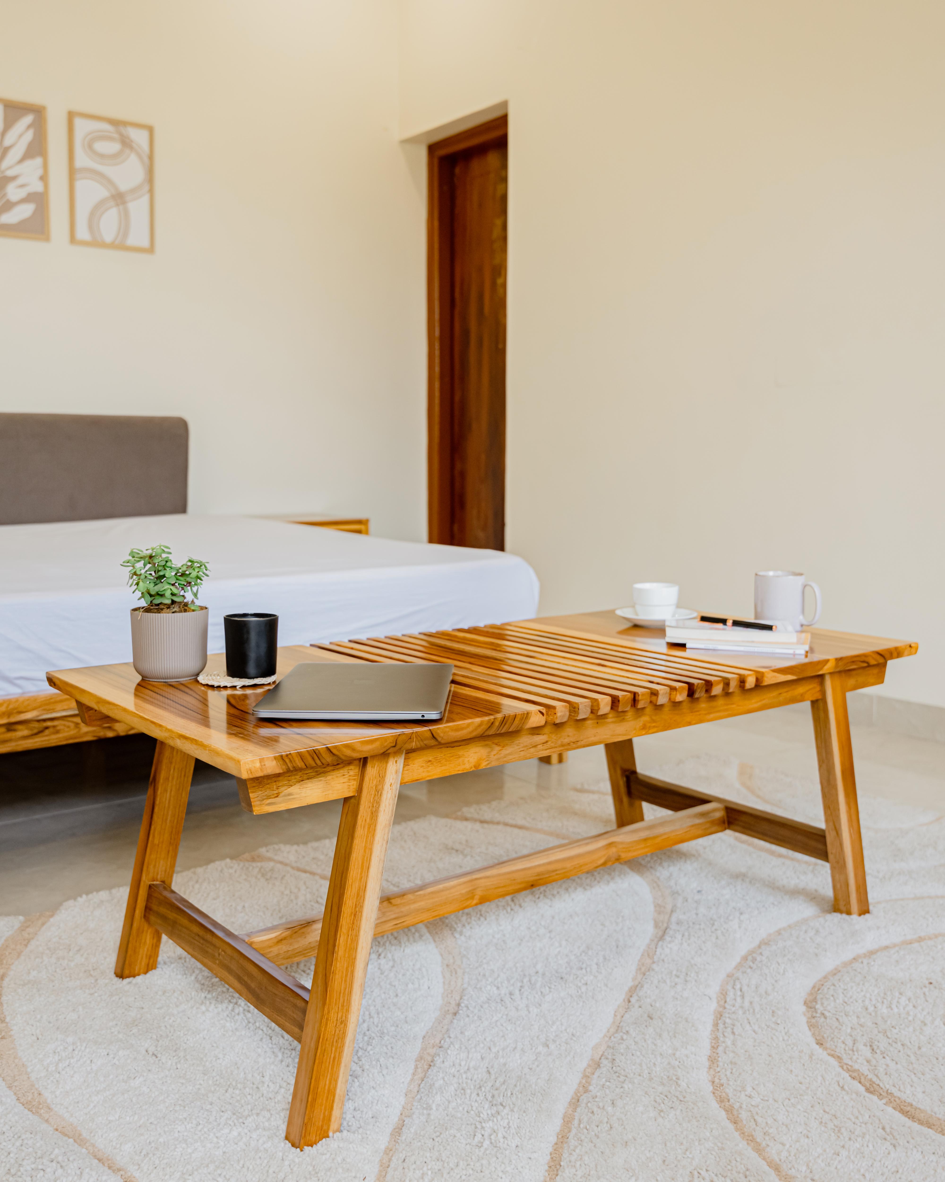 Wooden coffee table with items in a living room setting